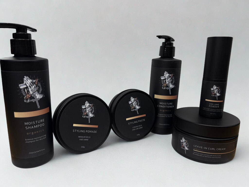 Set of hair care products including shampoo, pomade, and cream on a white background